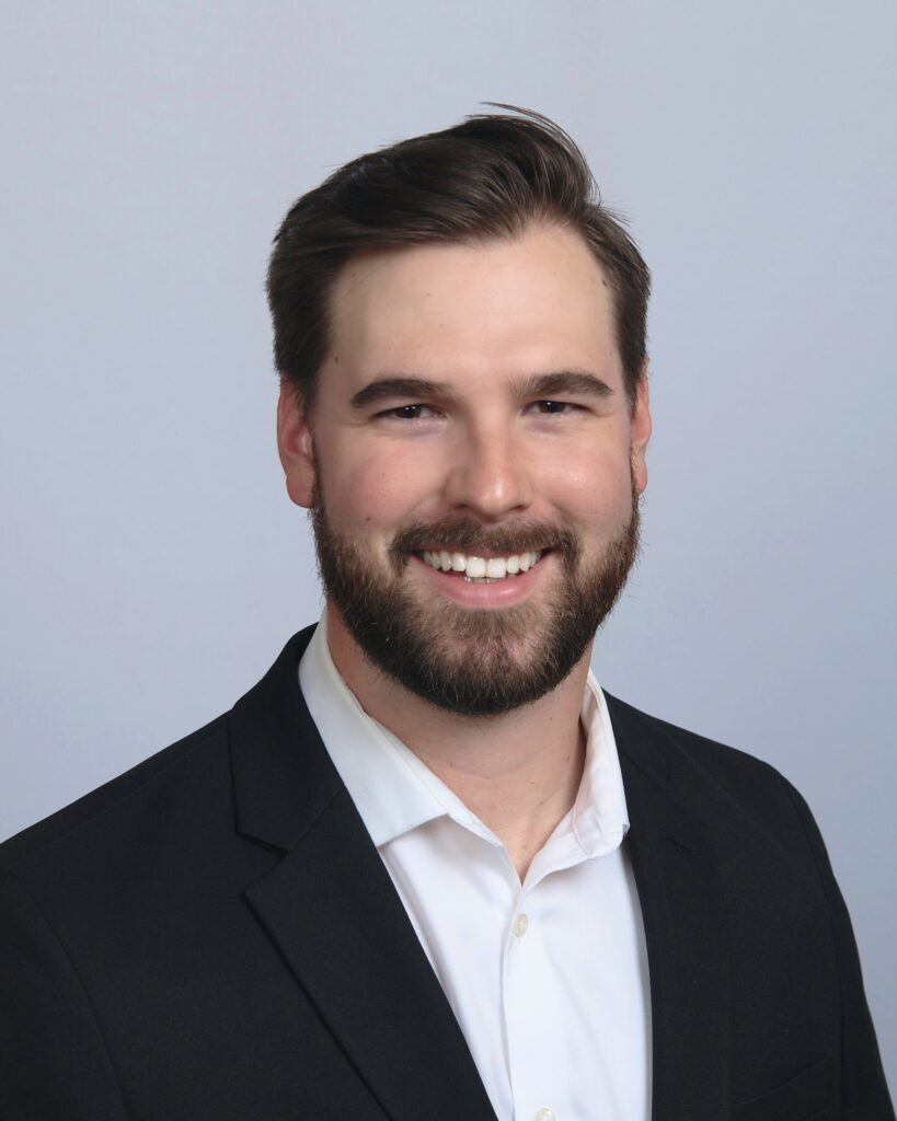 A man with a beard and suit jacket